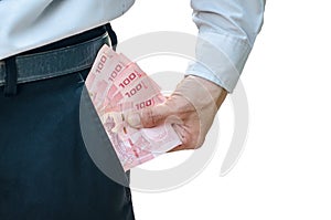 Businessman putting money in his pocket