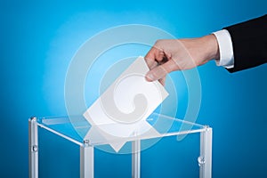 Businessman putting paper in election box