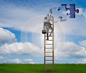 Businessman putting together jigsaw puzzle pieces