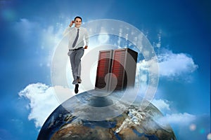 Businessman racing on top of the world beside server