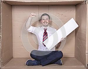 Businessman raises his hand clenched into a fist, copy space in the other hand