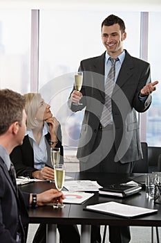 Businessman raising toast with champagne