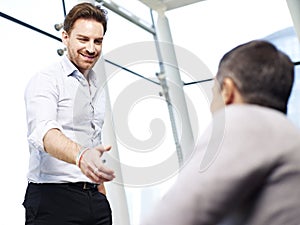 Businessman reaching out for a handshake