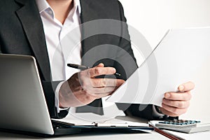 Businessman reading agreement documents