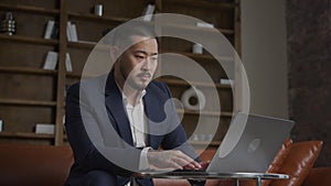 Businessman Reading Bad News on Laptop in Office