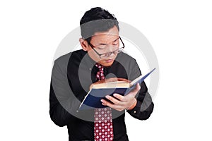 Businessman reading book, eye sight problem