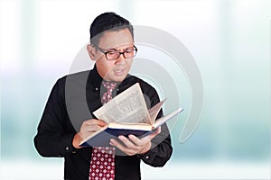 Businessman reading book, eye sight problem