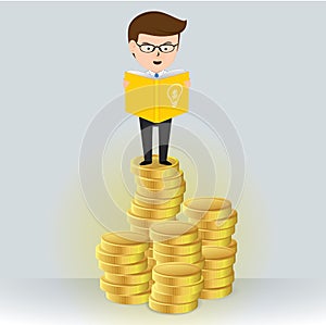 Businessman reading a book on a pile of gold coins