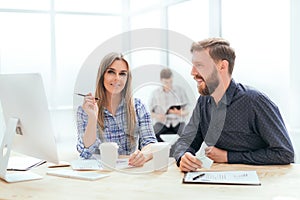 Businessman reading a business document sitting at his Desk