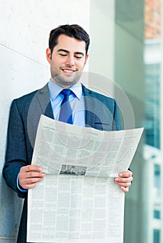 Businessman reading business newspaper