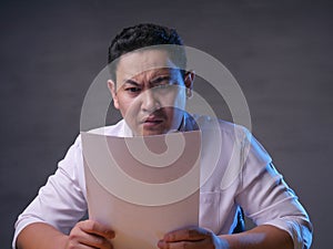 Businessman reading documents paper seriously