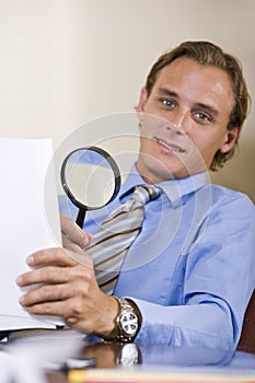 Businessman reading fine print in contract