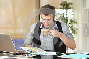 Businessman reading growth graph at office