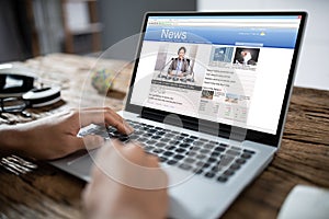 Businessman Reading News On Laptop