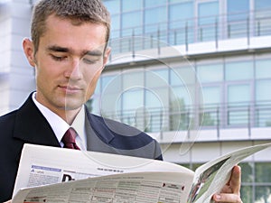 Businessman reading newspaper