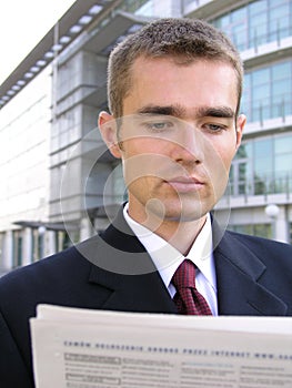 Businessman reading newspaper