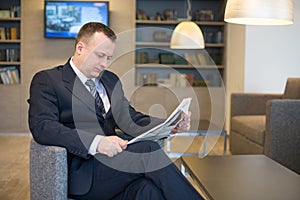 A businessman reading a newspaper