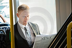 Businessman Reading Newspaper In Tram