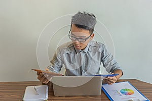 Businessman reading sale report in the office