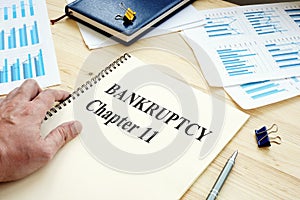 Businessman reads Bankruptcy Chapter 11 book photo