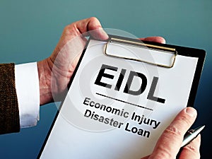 Businessman reads about EIDL The Economic Injury Disaster Loan Program