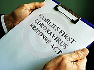 Businessman reads families first coronavirus response act FFCRA photo