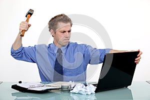 Businessman ready to smash laptop