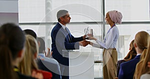 Businessman receiving award from businesswoman in the business seminar 4k