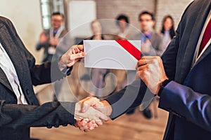 Businessman receiving award from businesswoman photo