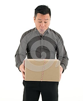 Businessman receiving a big package with surprise isolated on white background