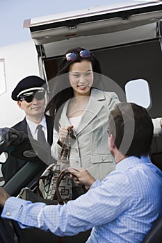Businessman Receiving Business Woman At Airfield