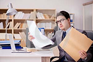 The businessman receiving letter envelope in office