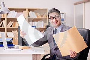 The businessman receiving letter in the office