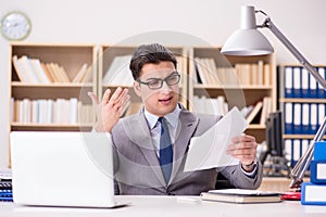 The businessman receiving letter in the office