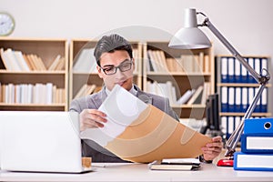 The businessman receiving letter in the office