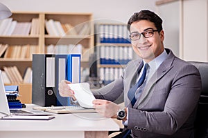 The businessman receiving letter in the office