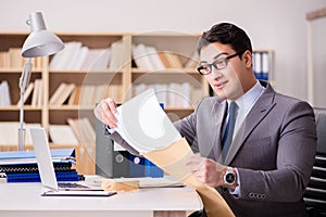 The businessman receiving letter in the office