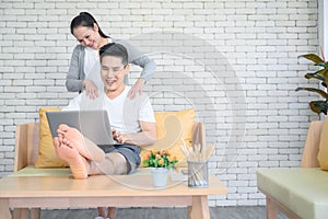 Businessman receiving massage from his girlfriend at home photo