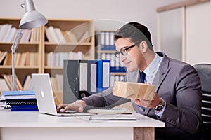 The businessman receiving parcel in office