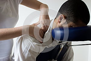 Businessman receiving shiatsu on a massage chair