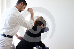 Businessman receiving shiatsu on a massage chair