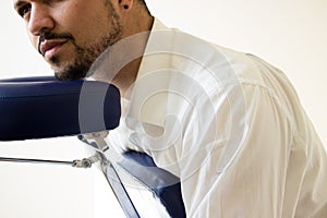 Businessman receiving shiatsu on a massage chair