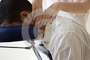 Businessman receiving shiatsu on a massage chair