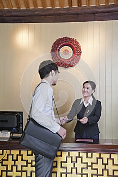 Businessman at Reception Desk of Hotel photo