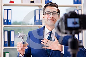 The businessman recording a video for vlog