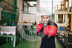 businessman with red gloves fight. for factory crisis