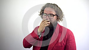 A businessman in a red suit and glasses yawns.Tired and Sleepy Man.