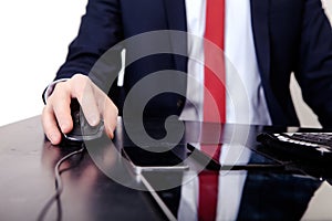 Businessman in red tie working on the computer. On the table is