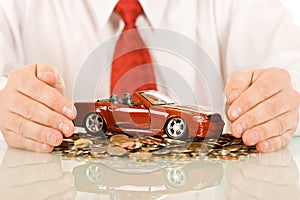 Businessman with red toy car