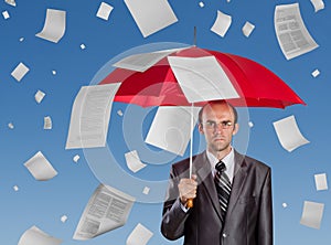 Businessman with red umbrella photo